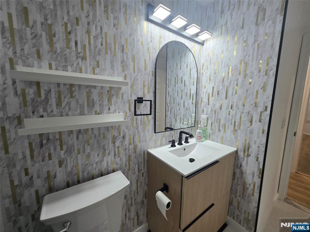 2080 Drake Court Mahwah, NJ 07430 - Photo 10 of 23 a bathroom with a sink mirror vanity and toilet