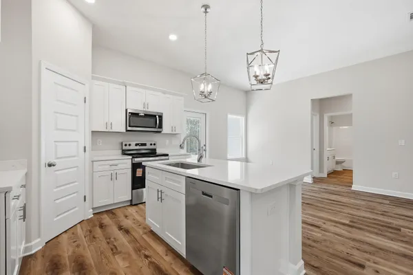 a kitchen with a sink and chandelier