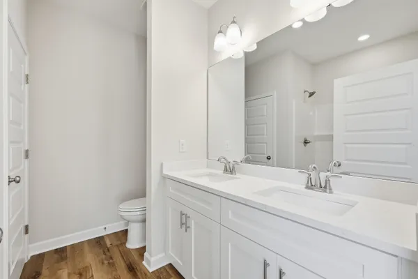 a bathroom with a tub shower vanity and a sink