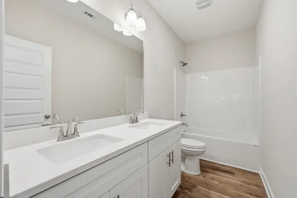 an empty room with closet and windows