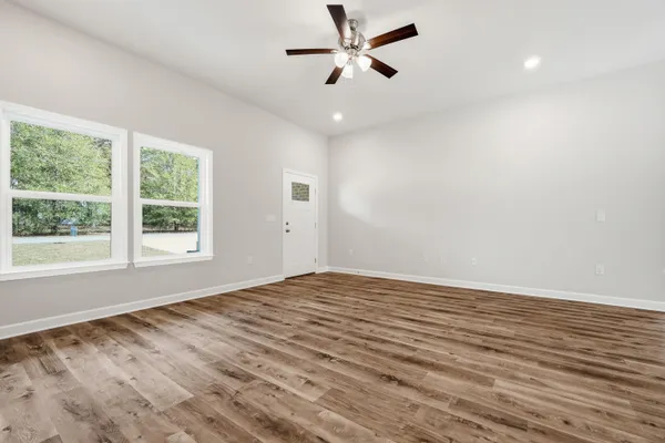 a view of kitchen with wooden floor electronic appliances and window
