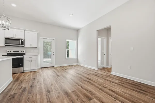 a kitchen with stainless steel appliances a white stove top oven and sink