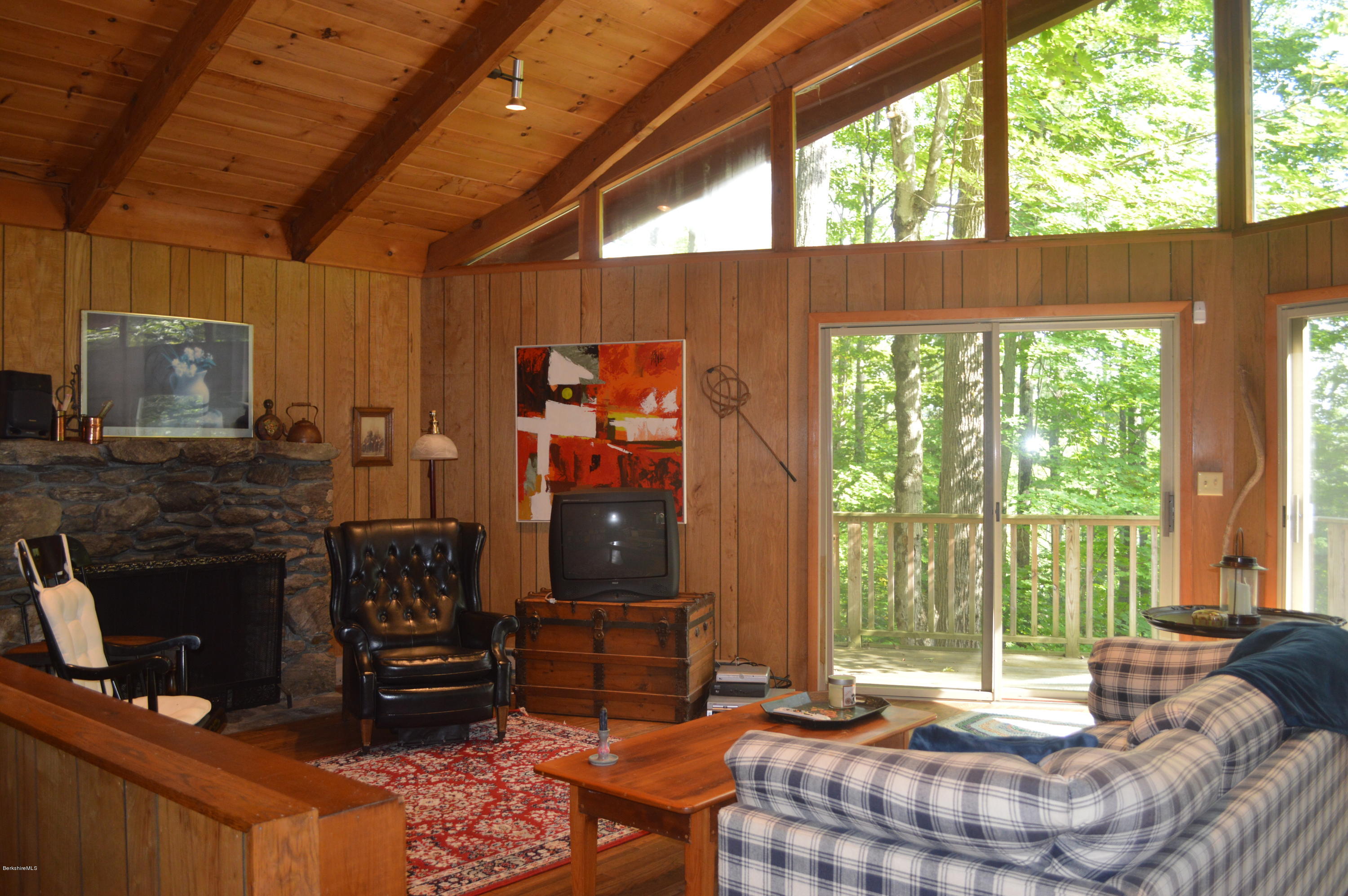 9 Mcdarby Road Tyringham, MA 01238 - Photo 2 of 15 a living room with furniture a flat screen tv and a fireplace