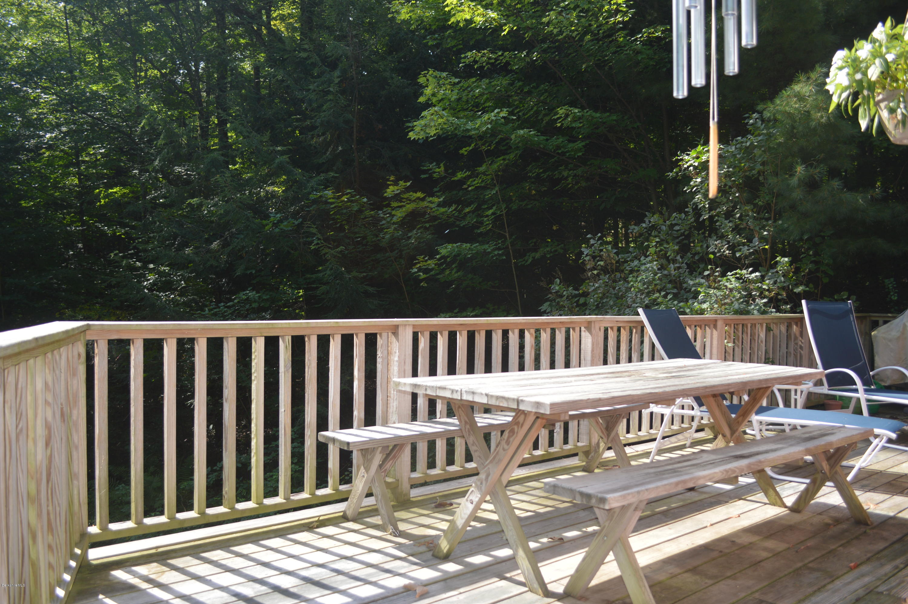 9 Mcdarby Road Tyringham, MA 01238 - Photo 11 of 15 a view of a wooden chairs and bench on the roof deck