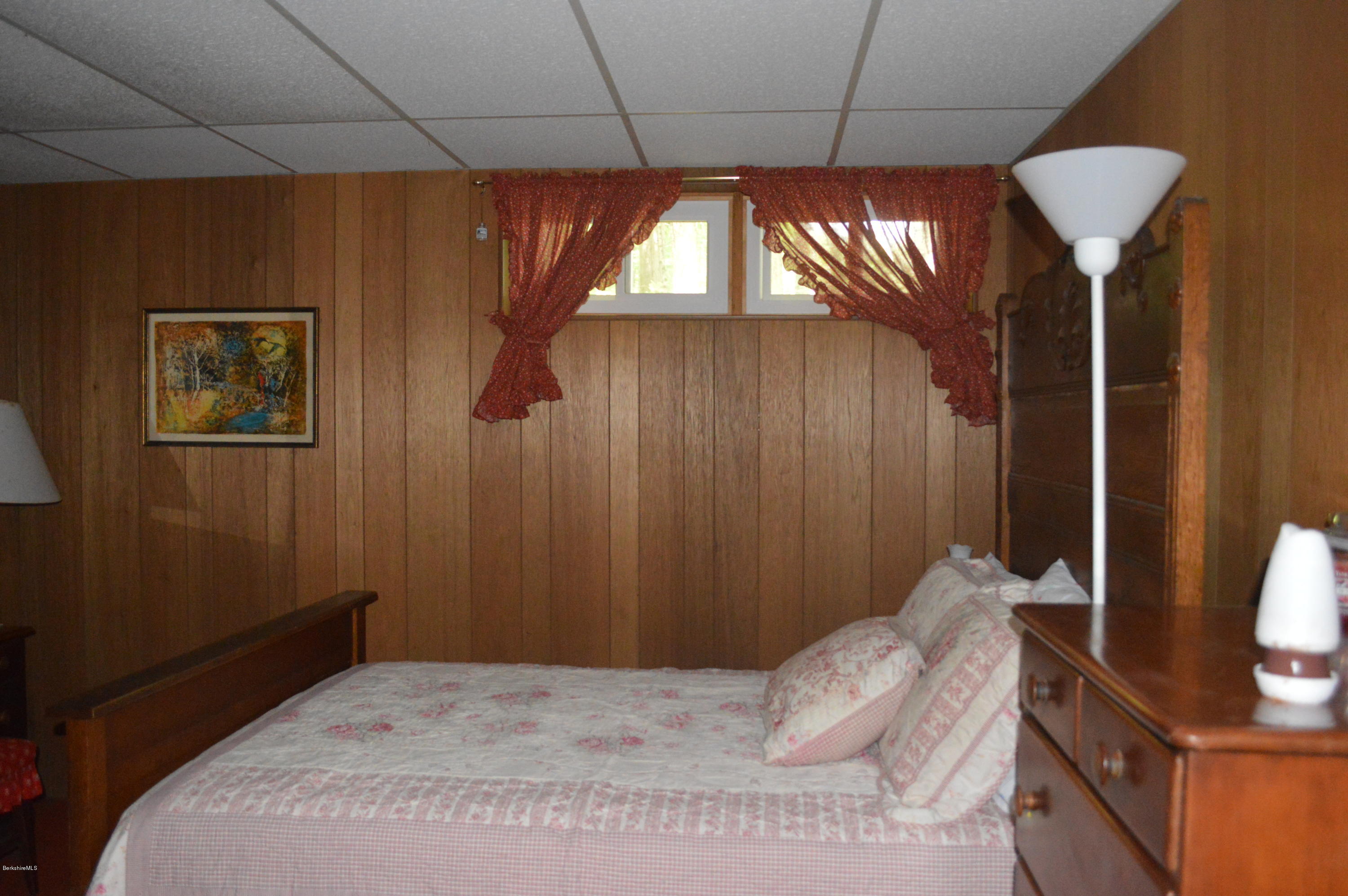 9 Mcdarby Road Tyringham, MA 01238 - Photo 8 of 15 a bedroom with a bed and a chandelier
