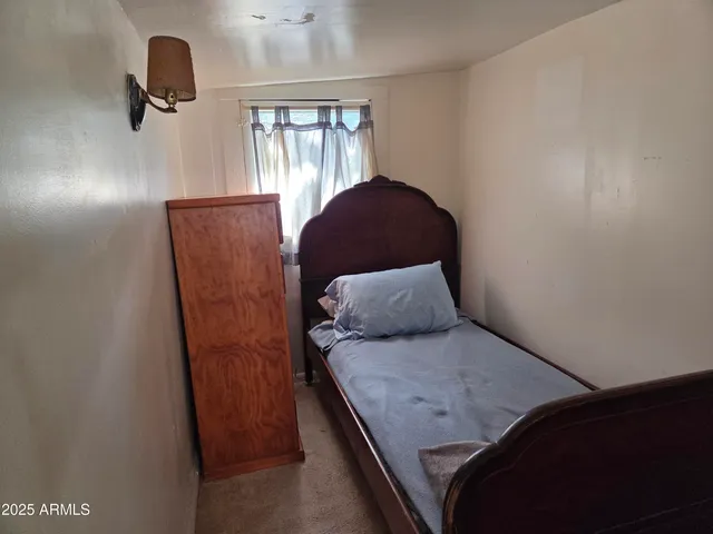 a bed room with a bed and a window