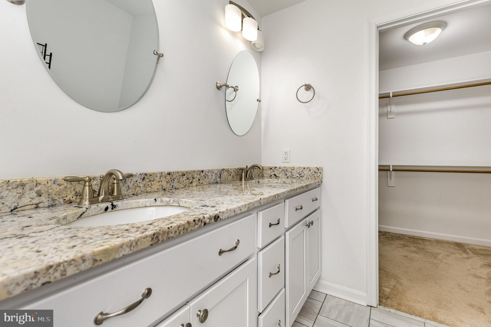 5428 Ridge Road Spotsylvania, VA 22551 - Photo 20 of 63 Elegant dual-sink bathroom with modern finishes.