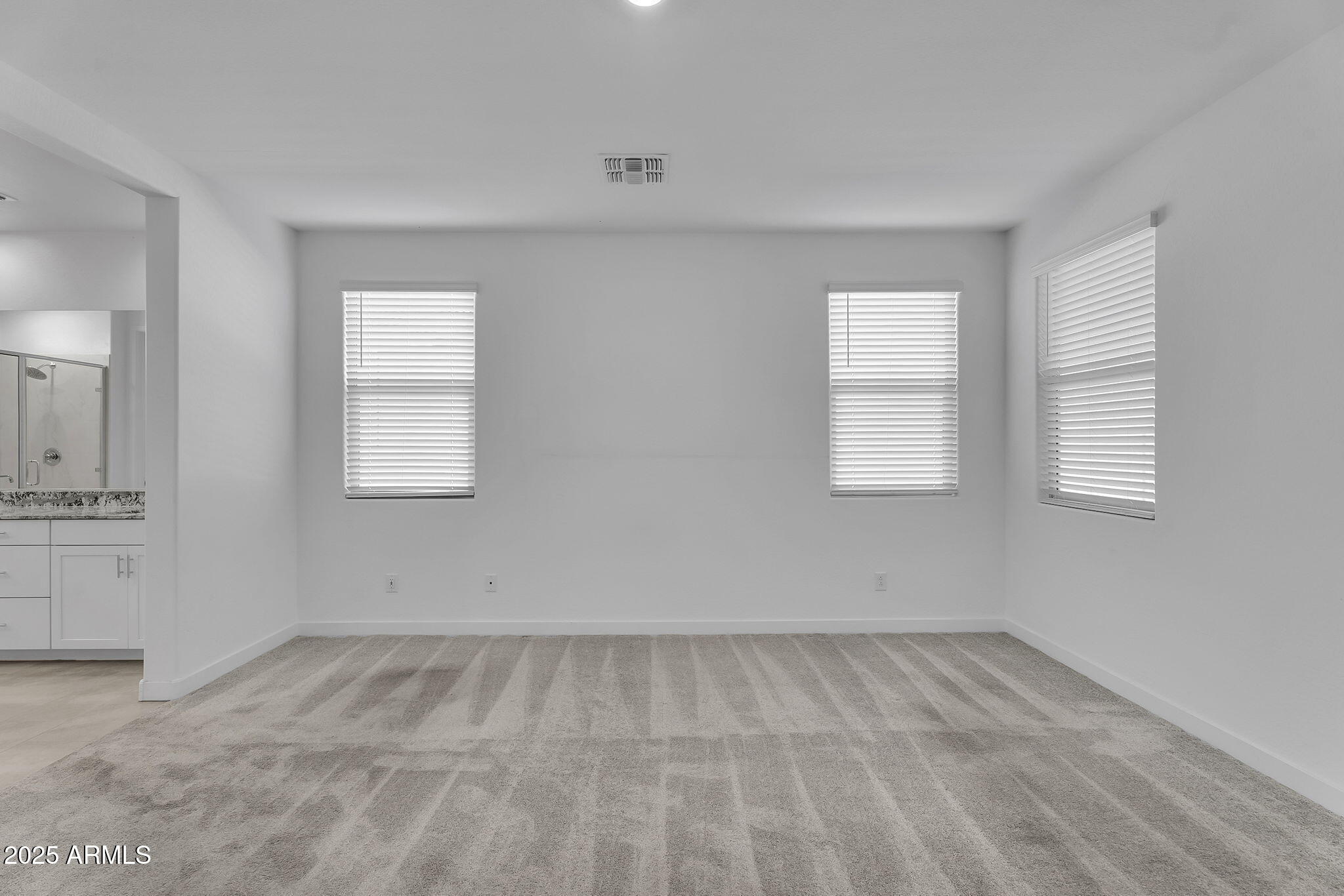 19948 West Flower Street Buckeye, AZ 85396 - Photo 12 of 58 wooden floor in an empty room with a window