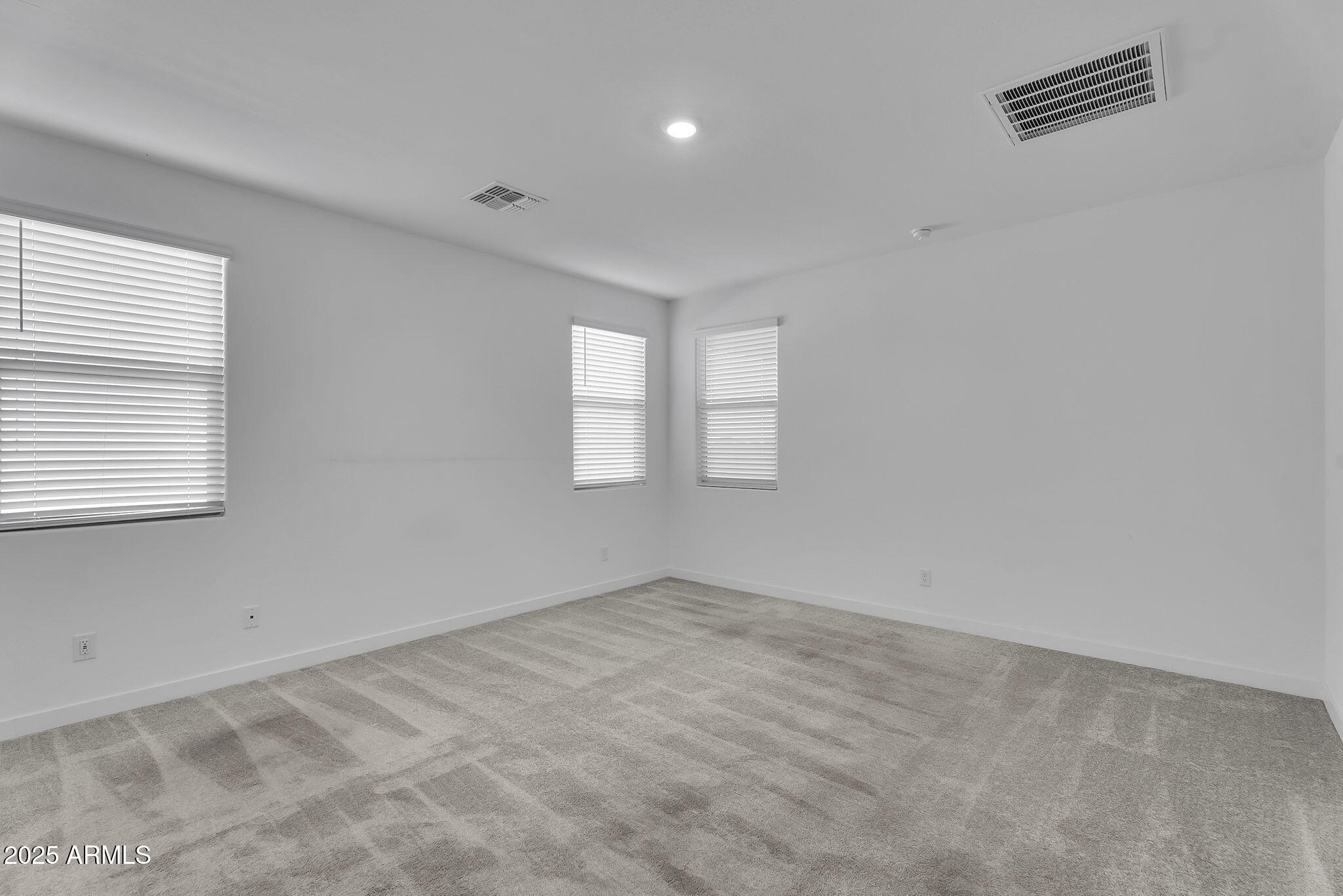 19948 West Flower Street Buckeye, AZ 85396 - Photo 16 of 58 a view of empty room with windows