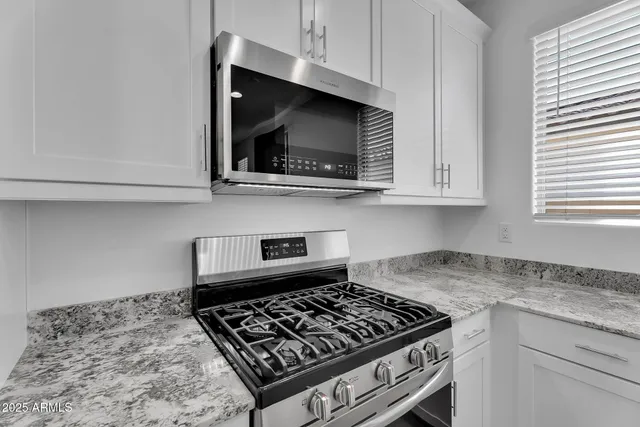 a view of kitchen with refrigerator sink and wooden floor