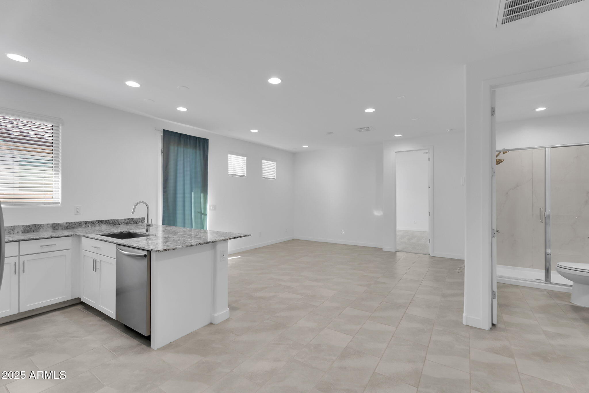 19948 West Flower Street Buckeye, AZ 85396 - Photo 21 of 58 a kitchen with stainless steel appliances granite countertop a sink and a stove