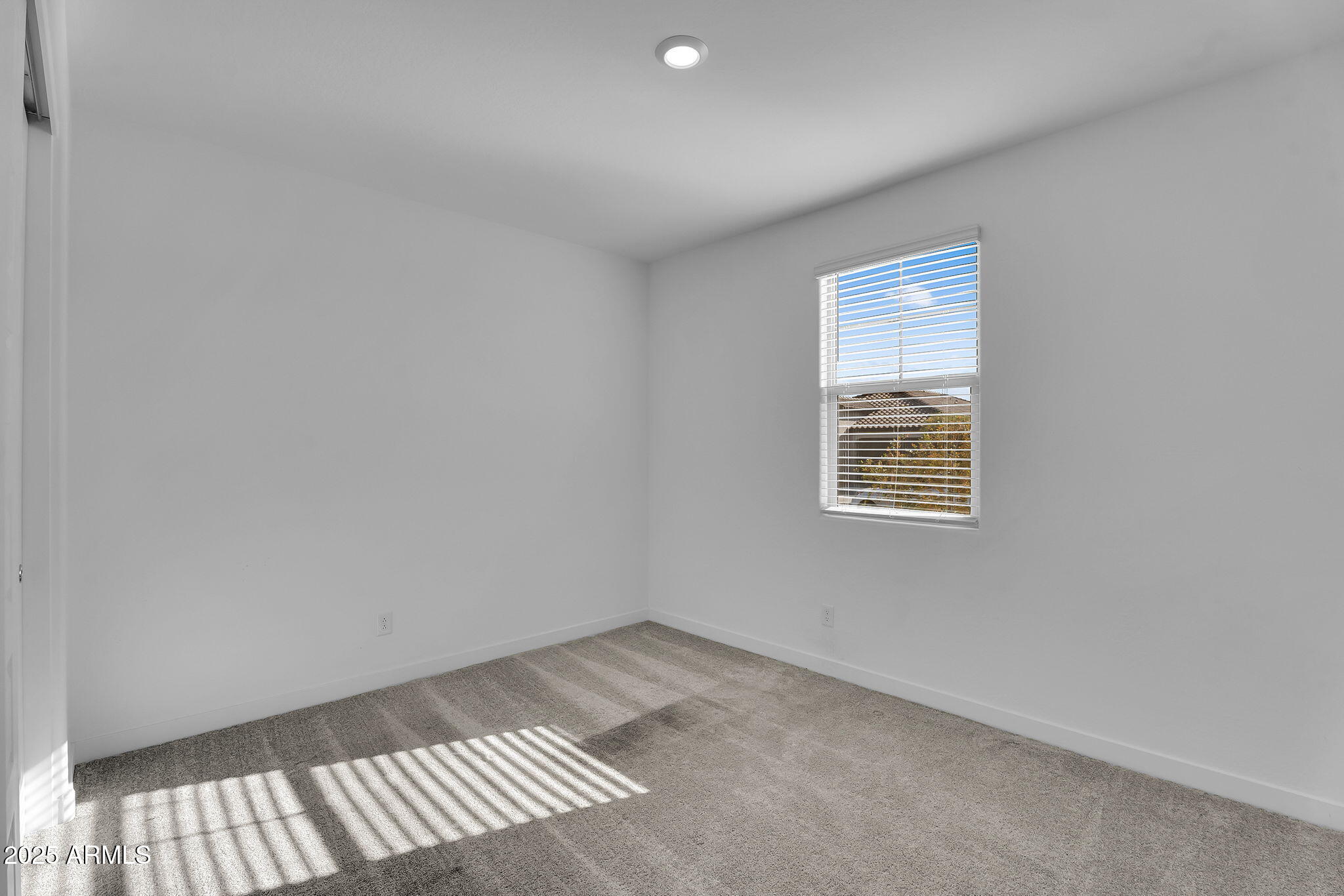 19948 West Flower Street Buckeye, AZ 85396 - Photo 25 of 58 a view of an empty room with a window
