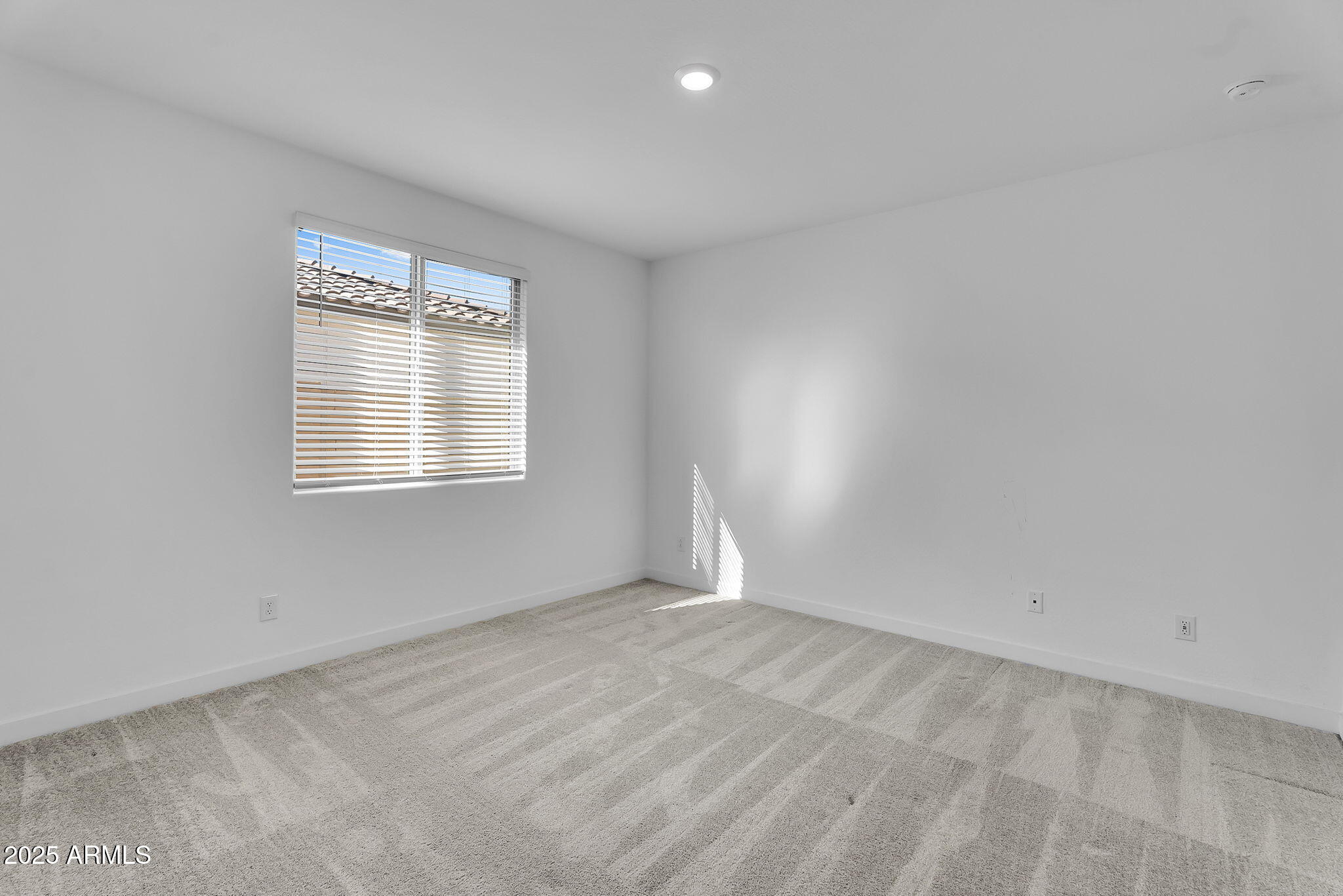 19948 West Flower Street Buckeye, AZ 85396 - Photo 30 of 58 a view of an empty room with a window