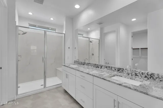 a bathroom with a shower and a glass door