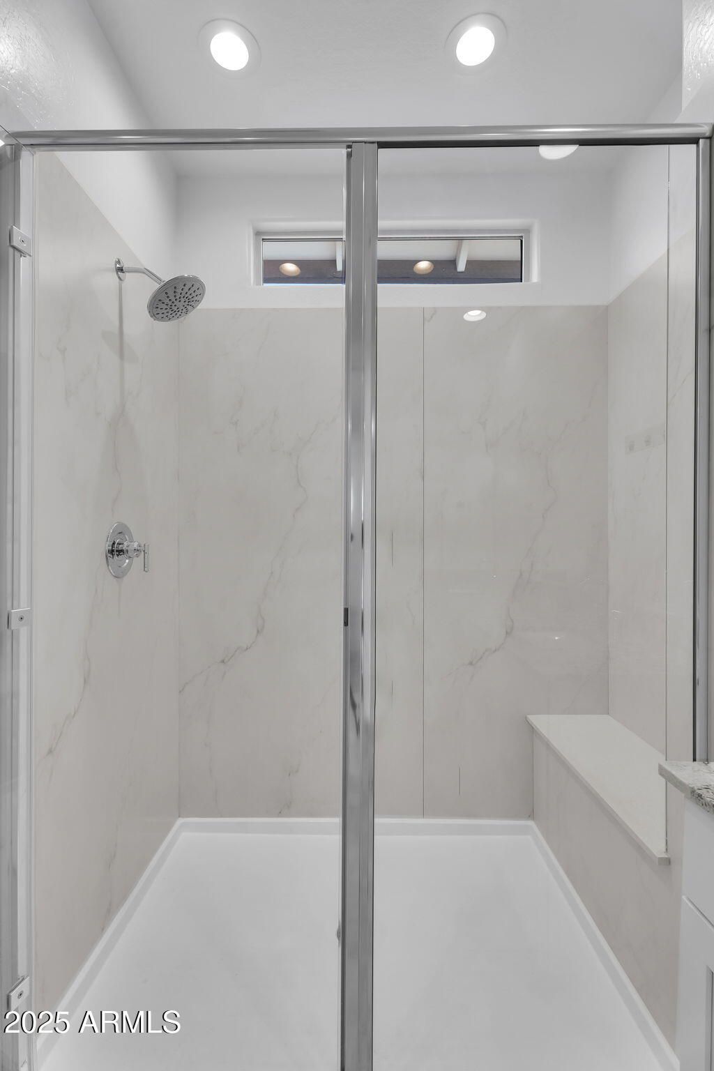 19948 West Flower Street Buckeye, AZ 85396 - Photo 36 of 58 a bathroom with a shower and a glass door