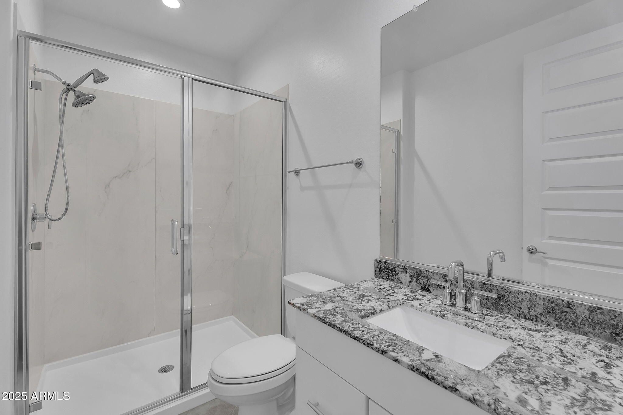 19948 West Flower Street Buckeye, AZ 85396 - Photo 39 of 58 a bathroom with a granite countertop sink toilet and shower