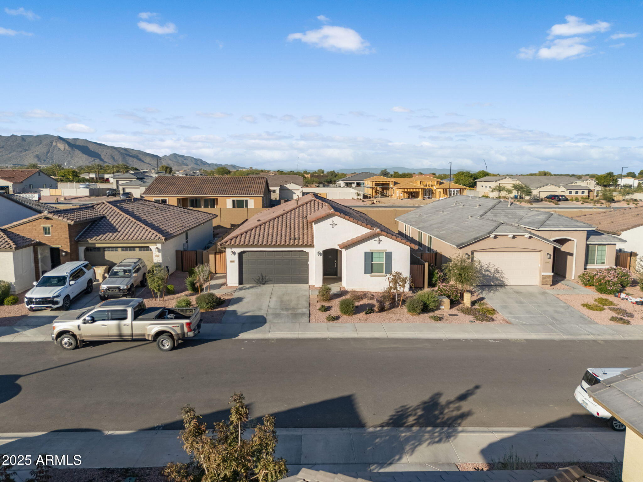 19948 West Flower Street Buckeye, AZ 85396 - Photo 50 of 58 an aerial view of residential houses and car parked on the street side