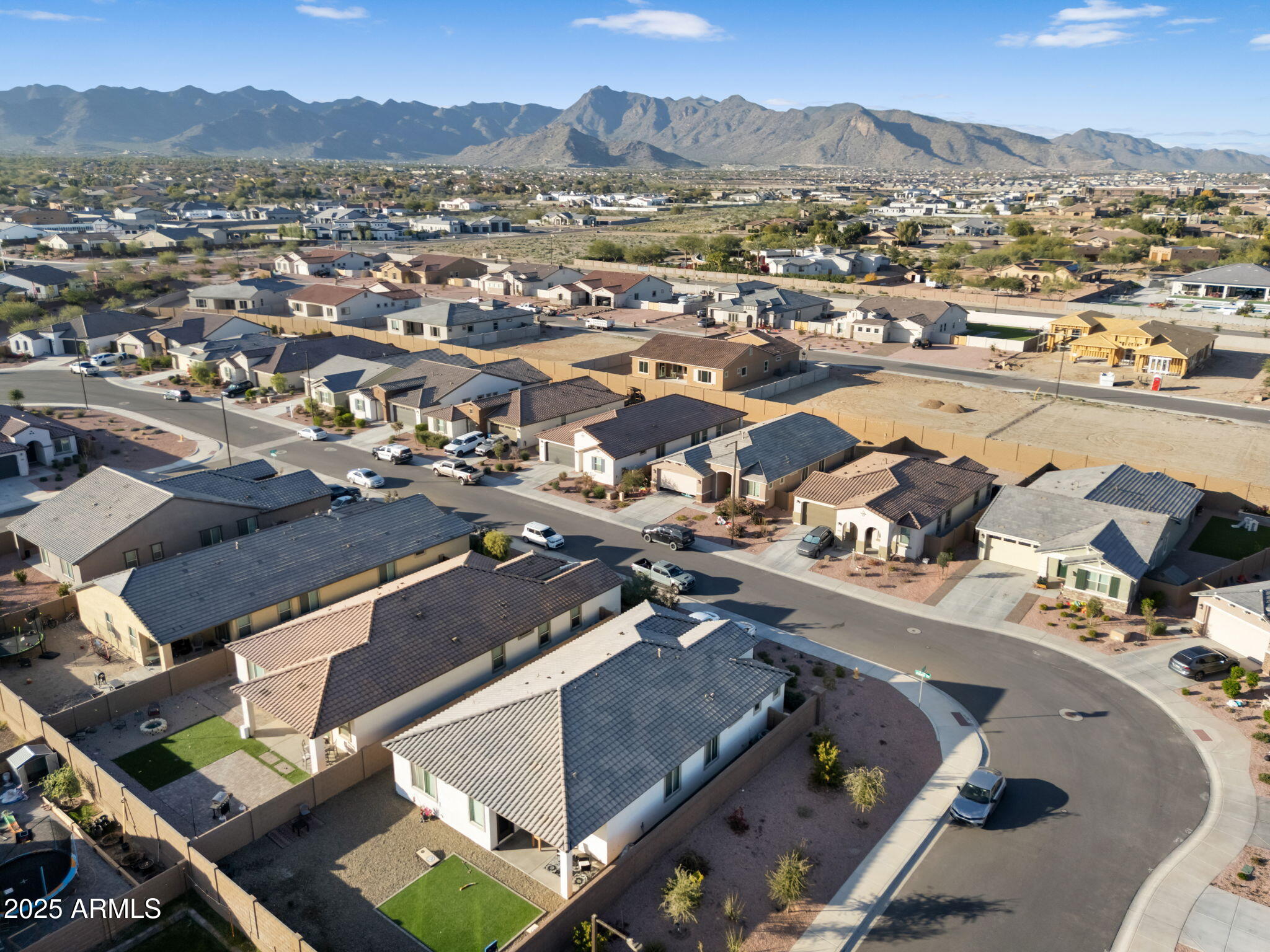 19948 West Flower Street Buckeye, AZ 85396 - Photo 57 of 58 an aerial view of a city with lots of residential buildings and mountain view in back