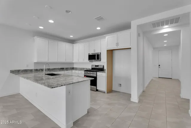 a kitchen with a sink stove and refrigerator