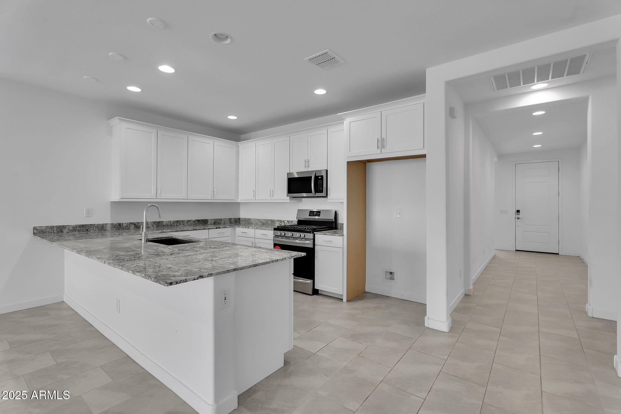 19948 West Flower Street Buckeye, AZ 85396 - Photo 6 of 58 a kitchen with a sink stove and refrigerator