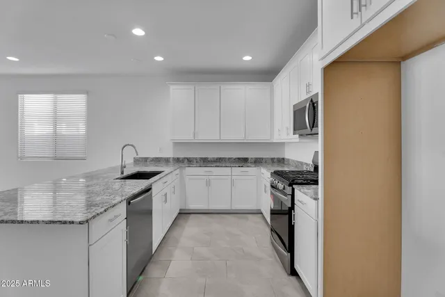 a kitchen with a sink stove and cabinets
