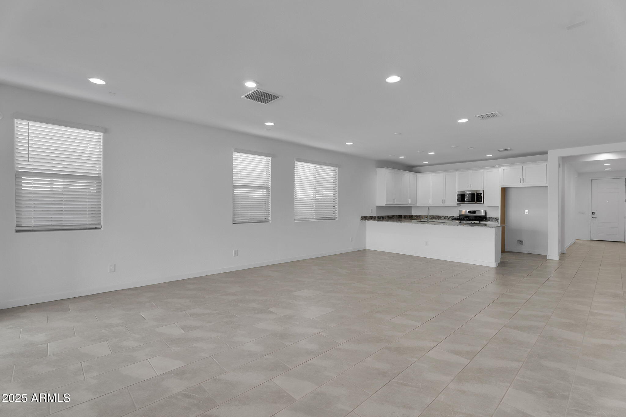 19948 West Flower Street Buckeye, AZ 85396 - Photo 8 of 58 a view of an empty room with kitchen view and window