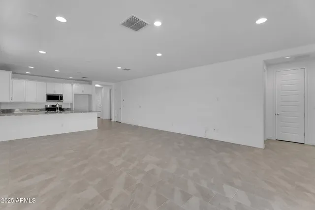a view of kitchen with kitchen island and stainless steel appliances