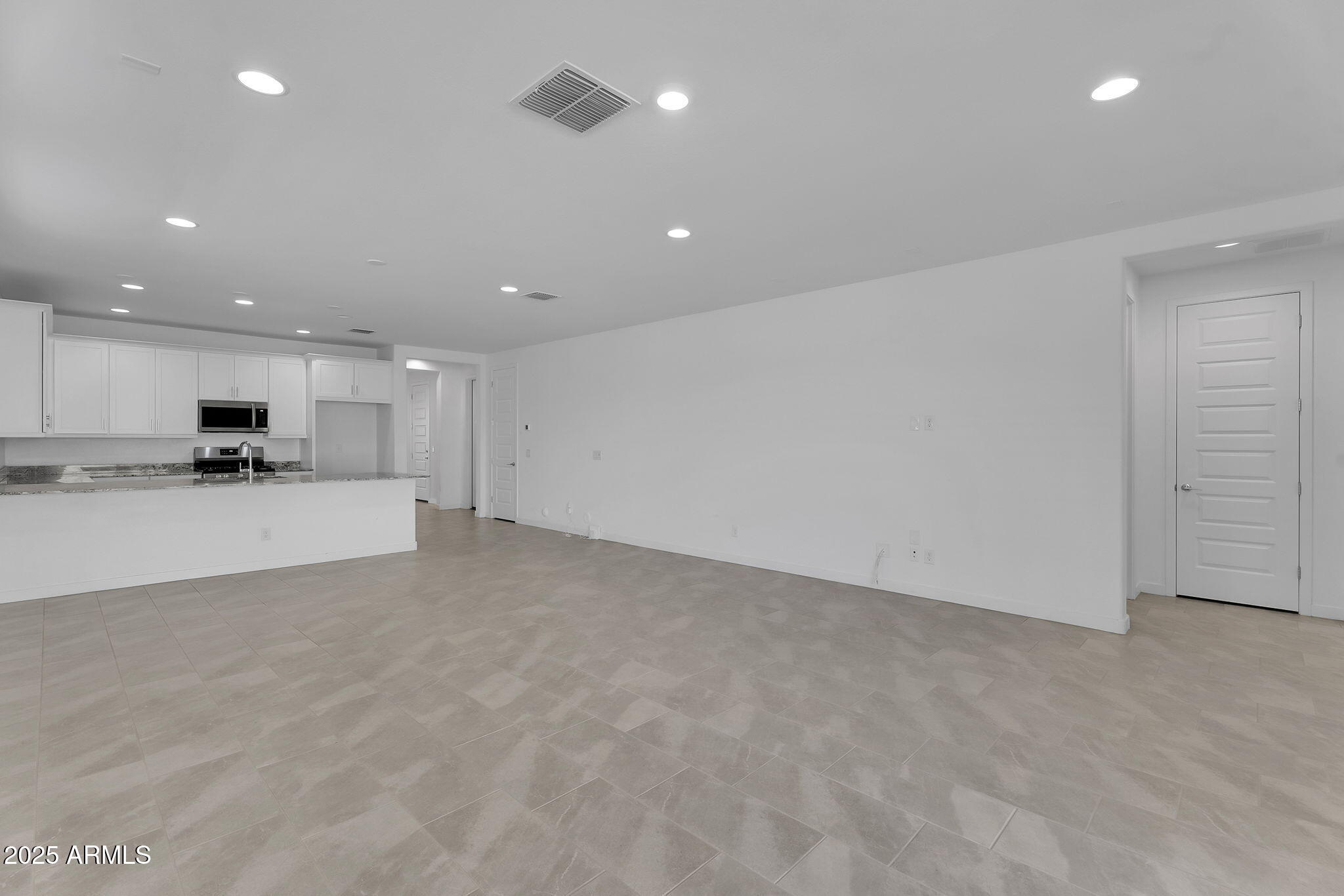 19948 West Flower Street Buckeye, AZ 85396 - Photo 9 of 58 a view of kitchen with kitchen island and stainless steel appliances