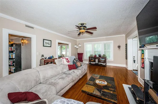 a large kitchen with stainless steel appliances granite countertop a sink dishwasher stove and refrigerator with wooden floor