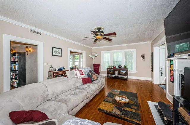 a large kitchen with stainless steel appliances granite countertop a sink dishwasher stove and refrigerator with wooden floor