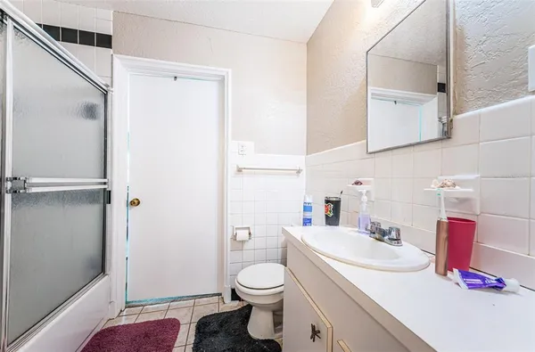 a view of a patio with table and chairs and potted plants
