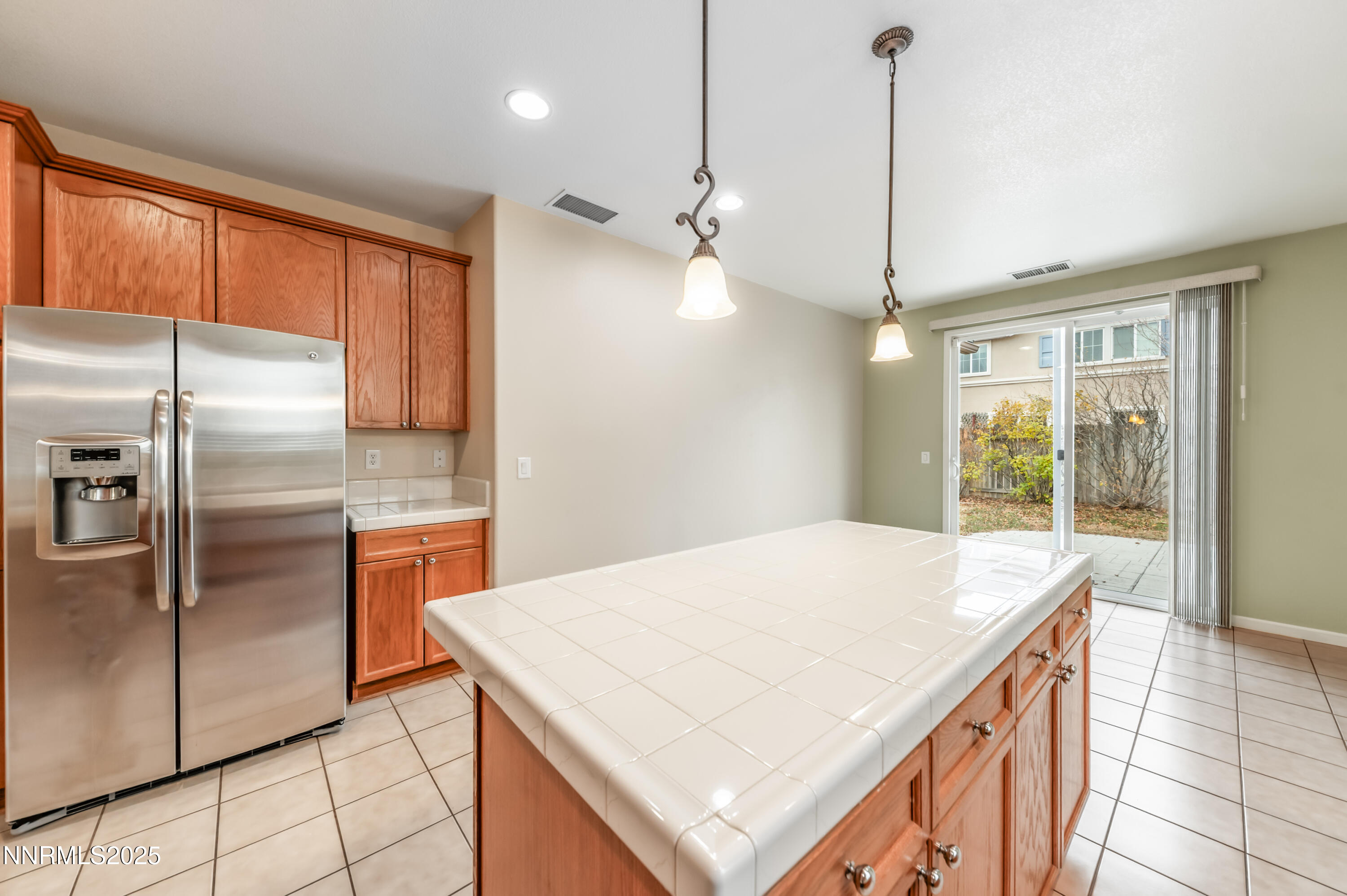 2180 Peaceful Valley Drive Reno, NV 89521 - Photo 14 of 31 a kitchen with kitchen island a counter top space appliances and a refrigerator