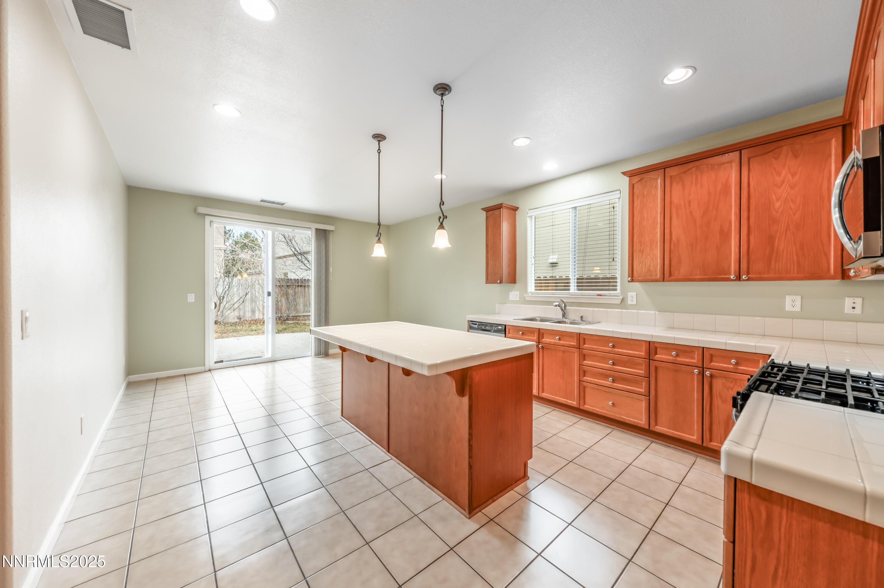 2180 Peaceful Valley Drive Reno, NV 89521 - Photo 9 of 31 a kitchen with stainless steel appliances granite countertop a stove a sink dishwasher and a refrigerator