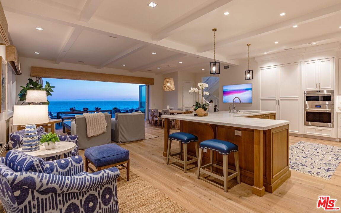 31412 Broad Beach Road Malibu, CA 90265 - Photo 28 of 32 a kitchen with stainless steel appliances kitchen island granite countertop a stove a sink a refrigerator and a living room view