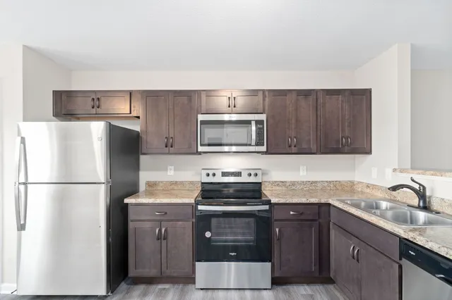 a kitchen with a refrigerator stove and sink