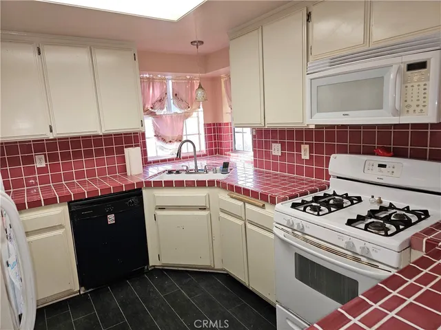 a living room with furniture and a ceiling fan
