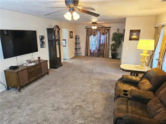 a view of living room with workspace and a flat screen tv