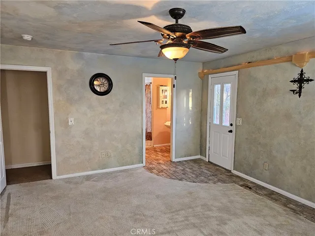 a view of a livingroom with wooden floor and window