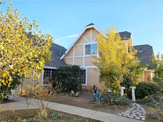 a view of a house with a yard and plants