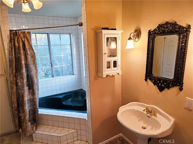 a bathroom with a toilet a sink and tub