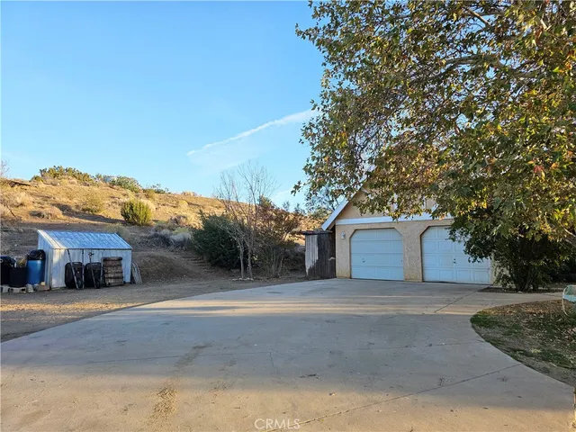 a view of barn house with large trees