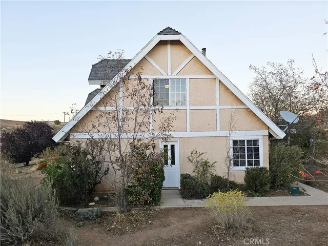 a view of a house with a yard and plants