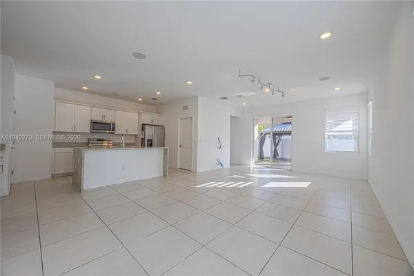 a kitchen with a sink window and cabinets