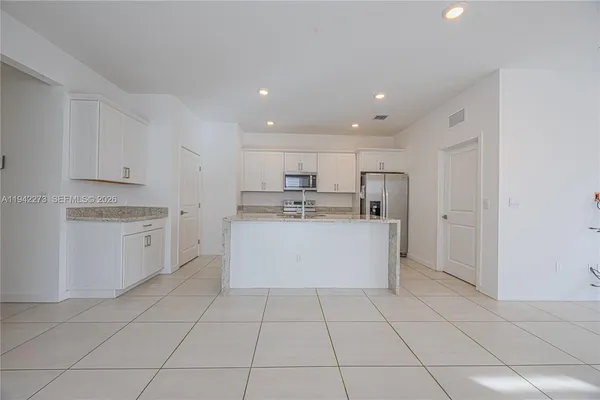 a kitchen with cabinets and stainless steel appliances