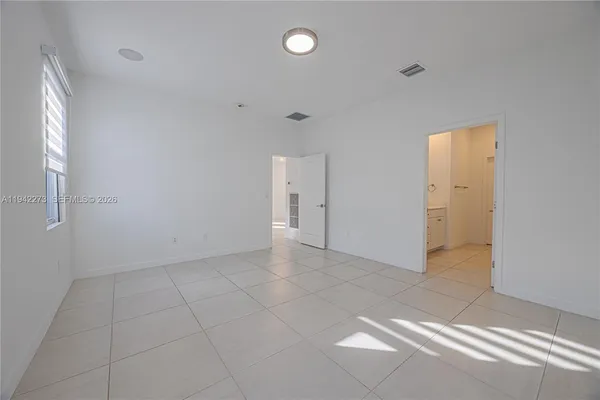 a spacious bathroom with a shower and a sink