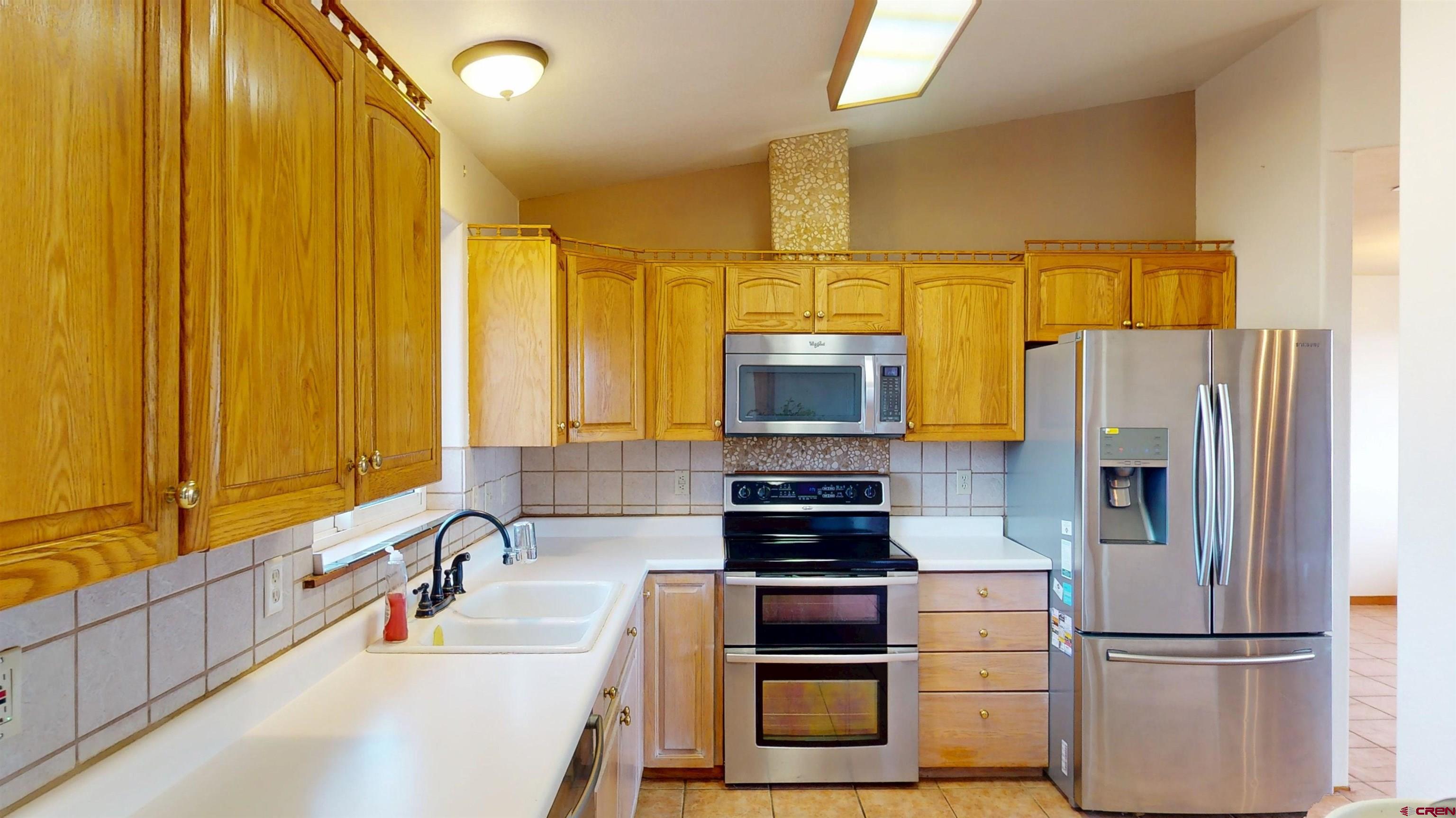 39865 Nelson Road Paonia, CO 81428 - Photo 15 of 38 a kitchen with stainless steel appliances a refrigerator sink and microwave