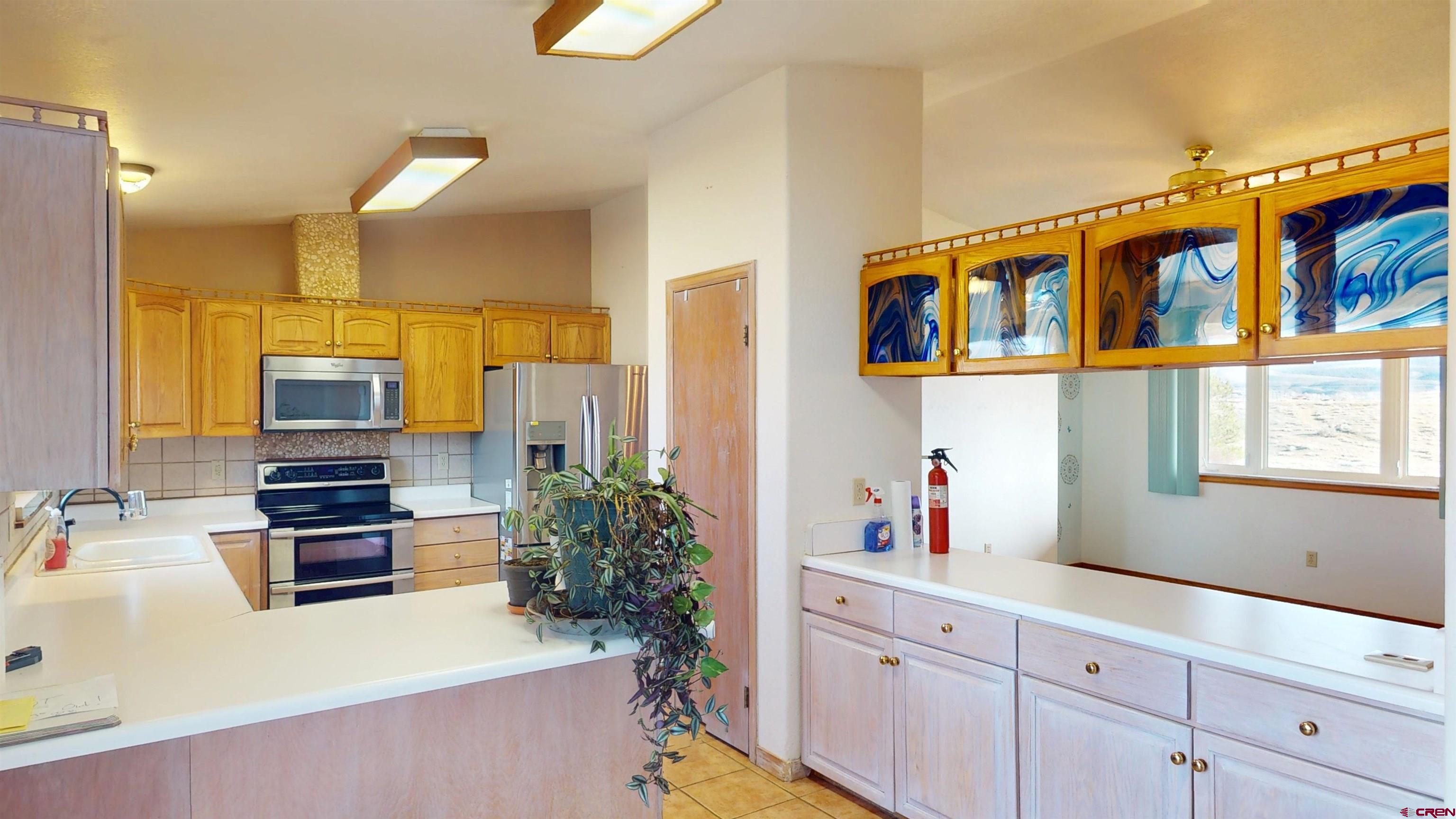 39865 Nelson Road Paonia, CO 81428 - Photo 16 of 38 a kitchen with stainless steel appliances a stove a sink and a refrigerator