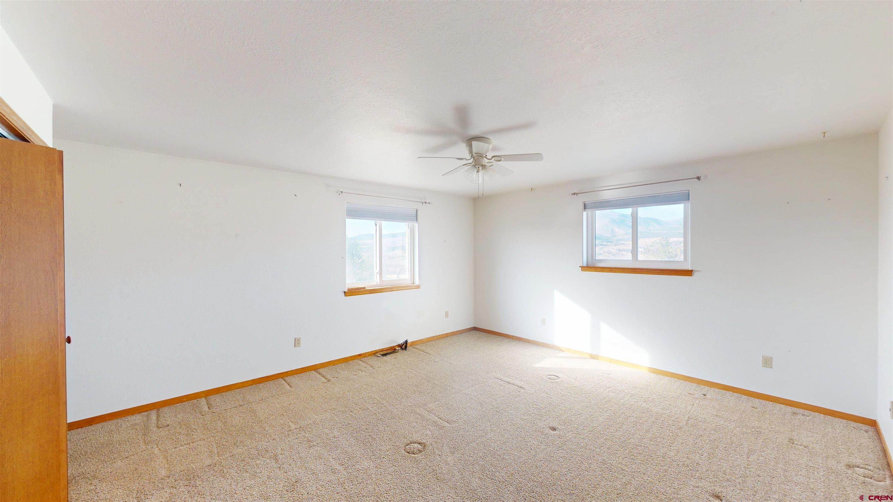 39865 Nelson Road Paonia, CO 81428 - Photo 20 of 38 an empty room with windows and fan