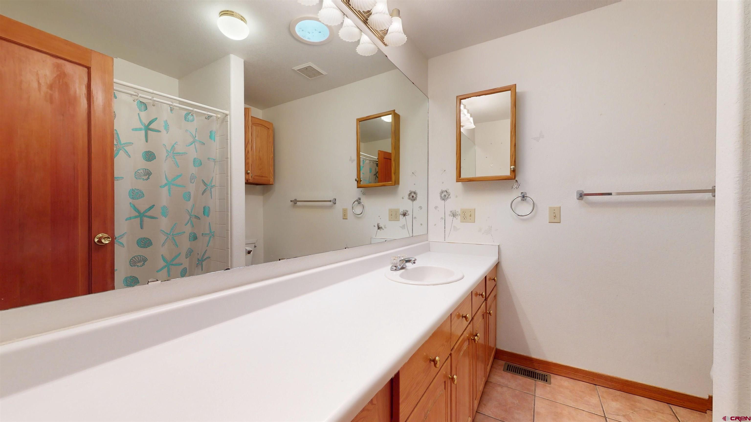 39865 Nelson Road Paonia, CO 81428 - Photo 26 of 38 a bathroom with a tub sink and mirror