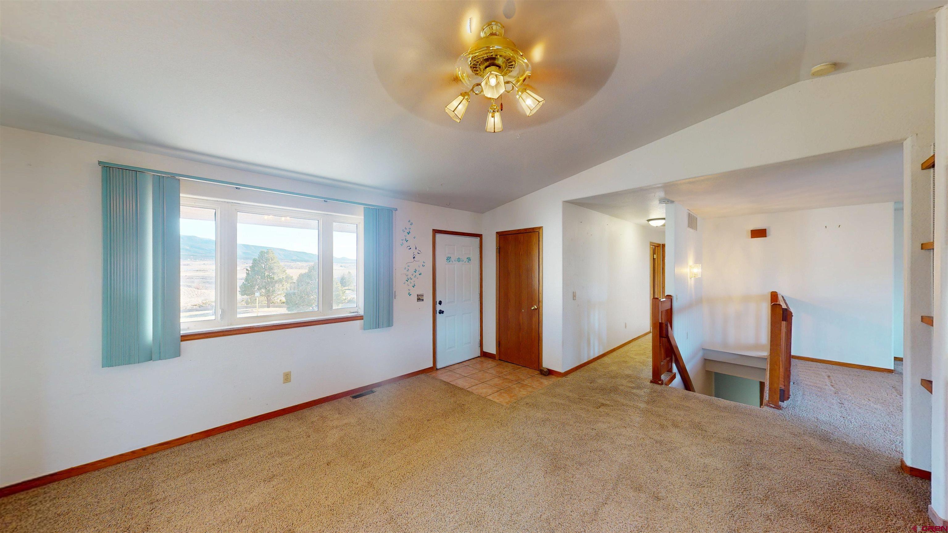 39865 Nelson Road Paonia, CO 81428 - Photo 10 of 38 a view of an empty room with window and a ceiling fan
